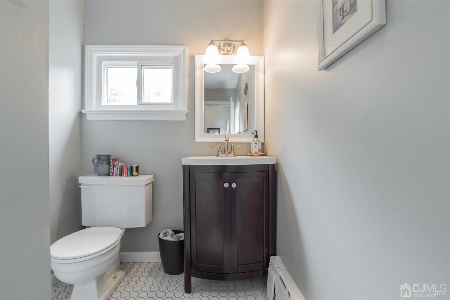 11 Station Road Cranbury, NJ 08512 - Photo 11 of 26 a bathroom with a toilet sink and mirror