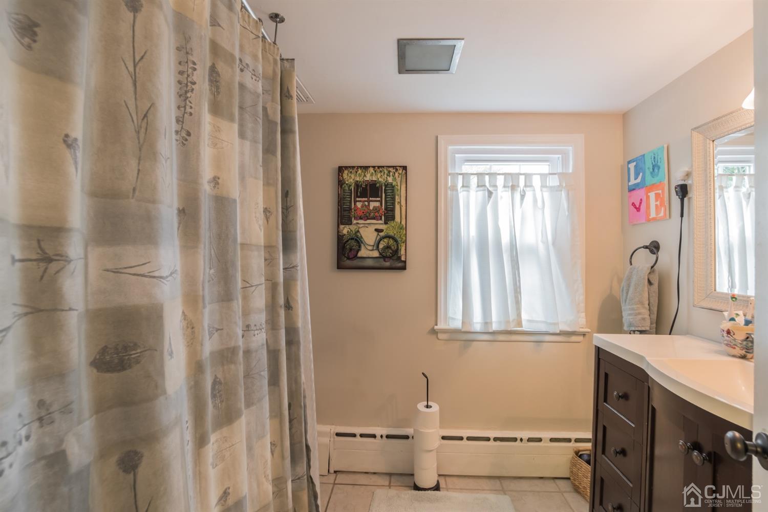 11 Station Road Cranbury, NJ 08512 - Photo 12 of 26 a bathroom with a sink and a mirror
