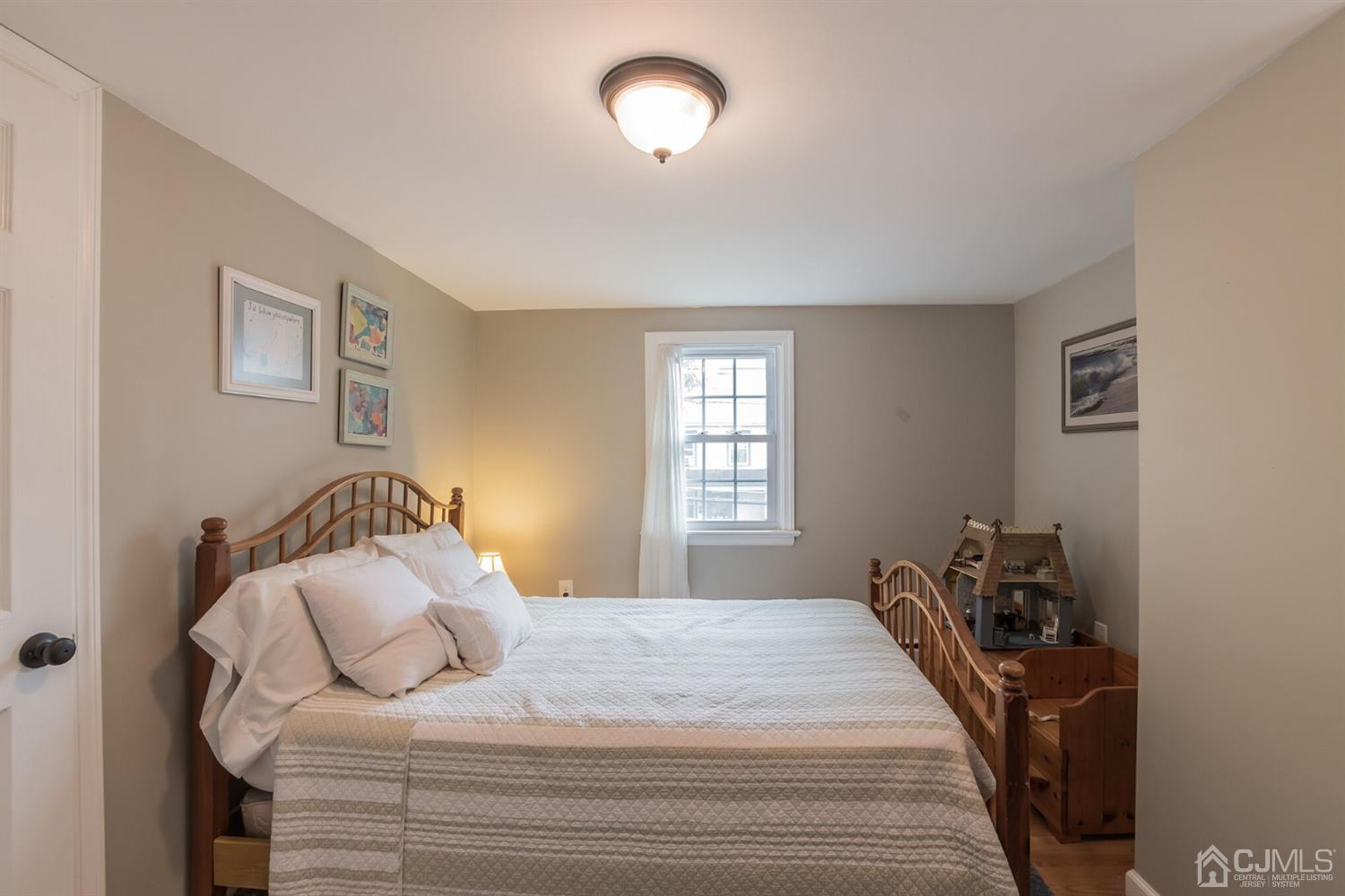 11 Station Road Cranbury, NJ 08512 - Photo 13 of 26 a bedroom with a bed and a window