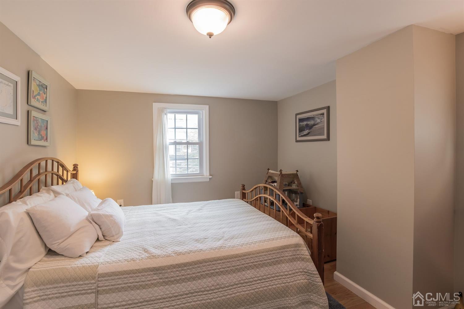 11 Station Road Cranbury, NJ 08512 - Photo 14 of 26 a bedroom with a bed and a window