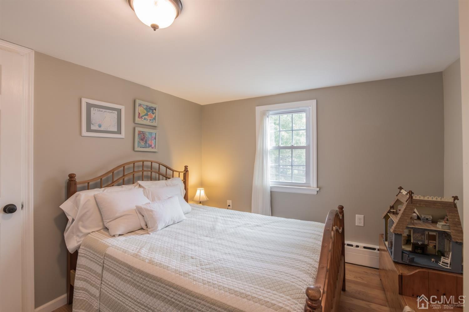 11 Station Road Cranbury, NJ 08512 - Photo 15 of 26 a bedroom with a bed and wooden floor