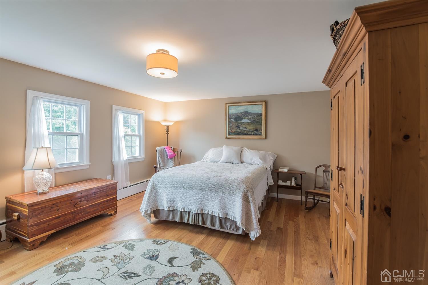 11 Station Road Cranbury, NJ 08512 - Photo 17 of 26 a bedroom with a bed and wooden floor