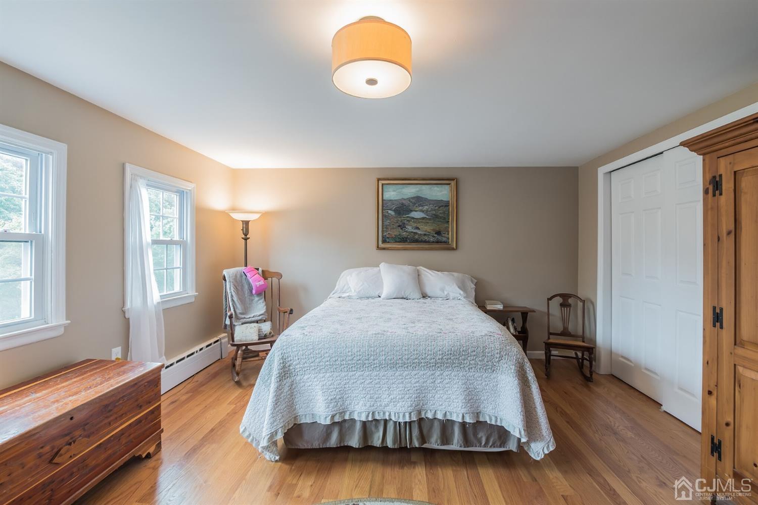 11 Station Road Cranbury, NJ 08512 - Photo 18 of 26 a spacious bedroom with a bed and a chandelier