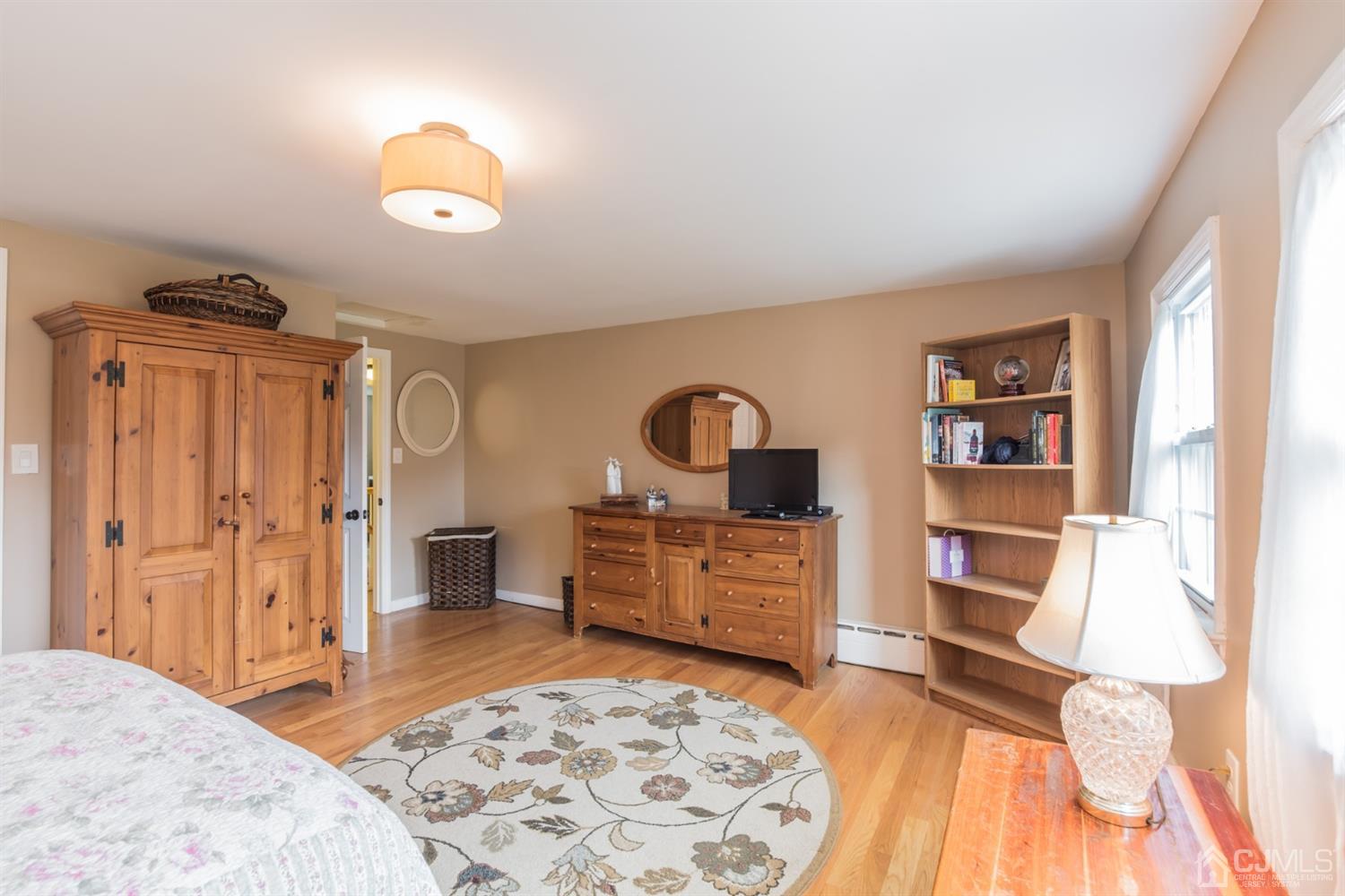 11 Station Road Cranbury, NJ 08512 - Photo 20 of 26 a bedroom with a bed and a dresser