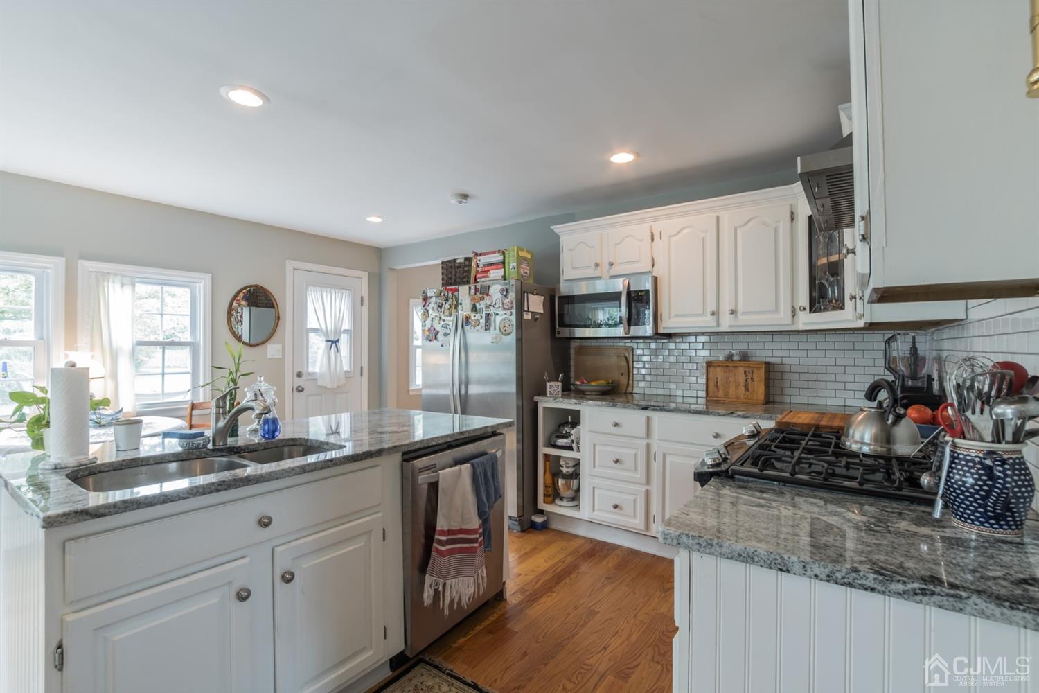 11 Station Road Cranbury, NJ 08512 - Photo 6 of 26 a kitchen with kitchen island granite countertop a sink cabinets and stainless steel appliances