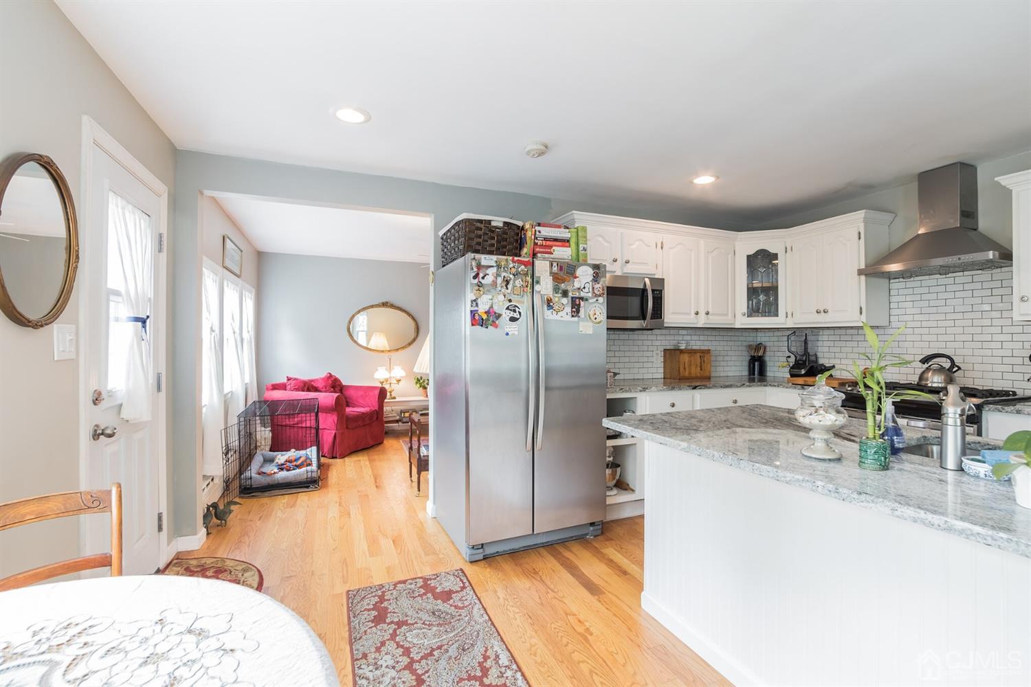 11 Station Road Cranbury, NJ 08512 - Photo 7 of 26 a kitchen with refrigerator and cabinets