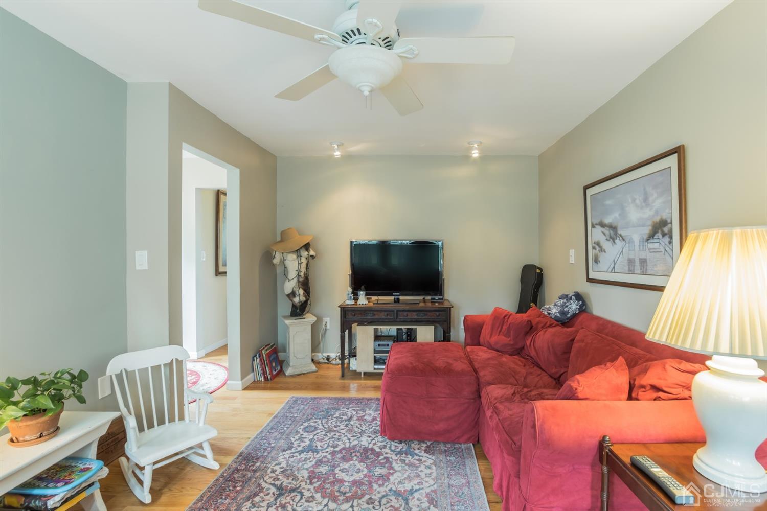11 Station Road Cranbury, NJ 08512 - Photo 9 of 26 a living room with furniture and a flat screen tv