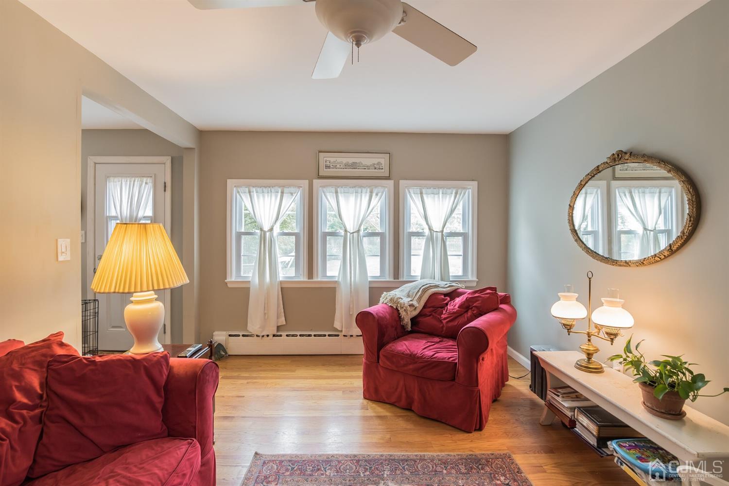 11 Station Road Cranbury, NJ 08512 - Photo 10 of 26 a living room with furniture fireplace and a large window