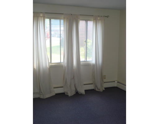 84 Manor Court, Unit 84 Springfield, MA 01118 - Photo 3 of 12 a view of an empty room with a window