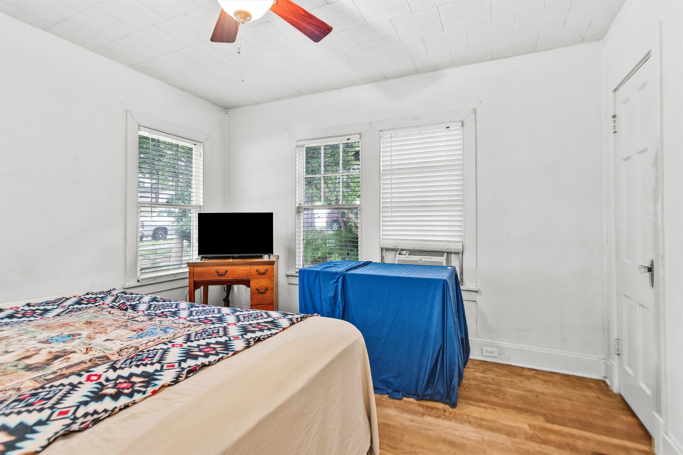 1720 18th Street Huntsville, TX 77340 - Photo 26 of 37 a bedroom with a bed and a flat screen tv