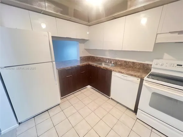 a kitchen with a sink and a refrigerator