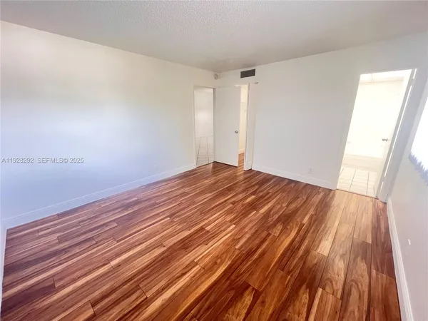 a view of room with wooden floor