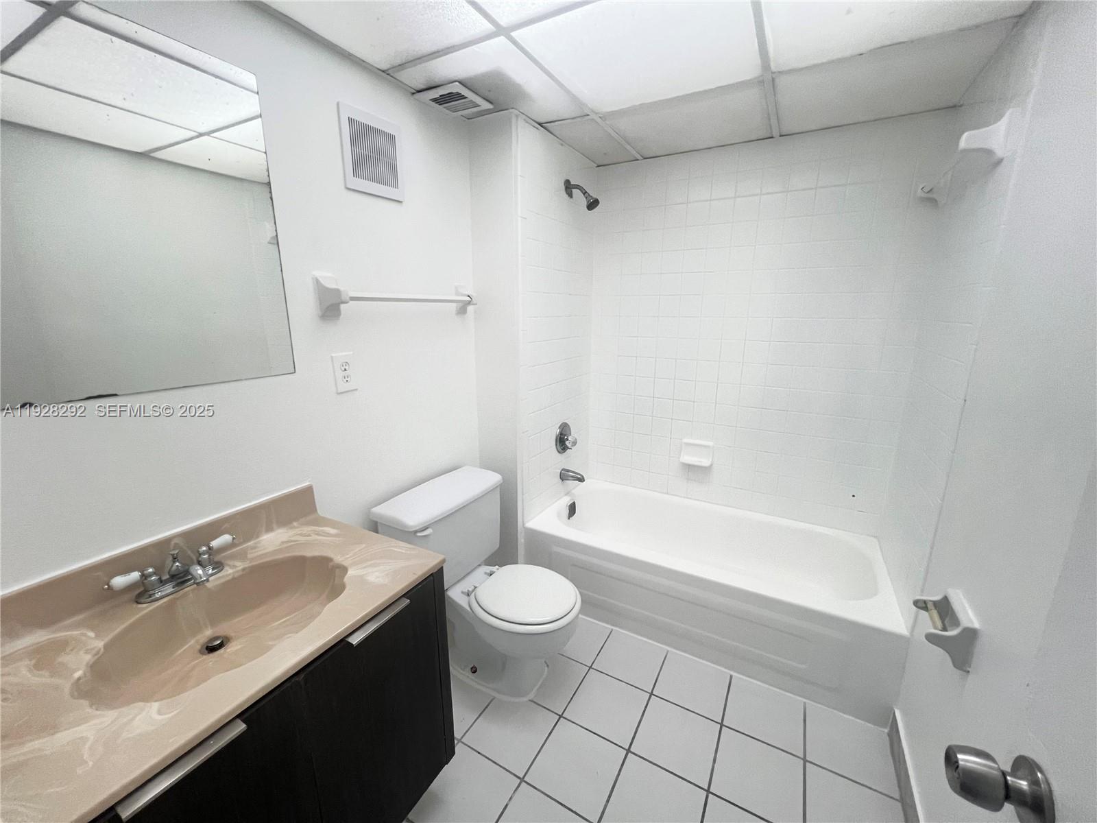 7820 South Colony Circle, Unit 301 Tamarac, FL 33321 - Photo 8 of 13 a bathroom with a sink a toilet and shower