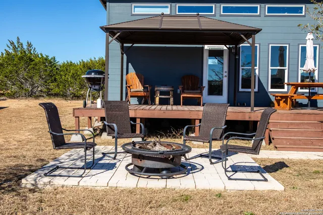 a view of a patio with table and chairs floor to ceiling window with wooden floor