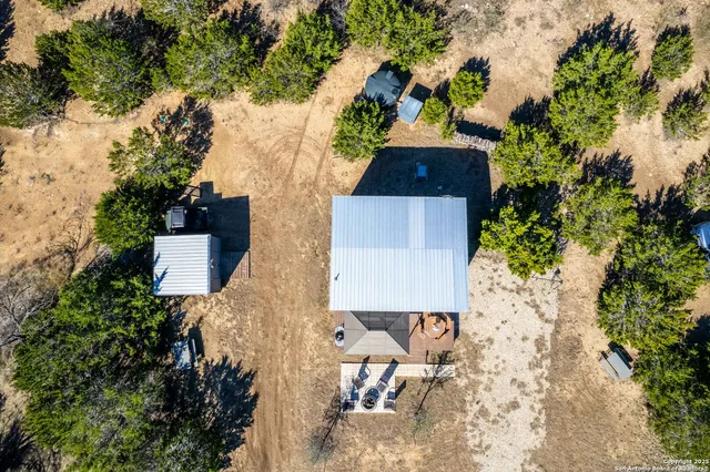 an aerial view of a house with a yard