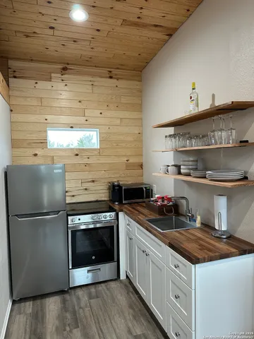 a kitchen with stainless steel appliances granite countertop a stove and a refrigerator