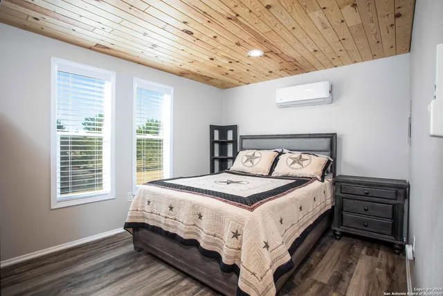 a bedroom with a bed next to a window