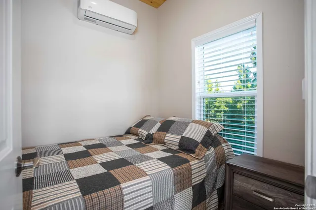 a bedroom with a bed and a window