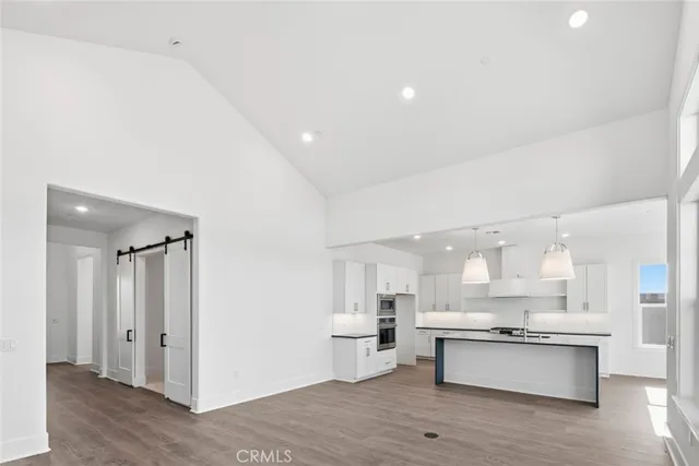 a large kitchen with a large counter top appliances and cabinets