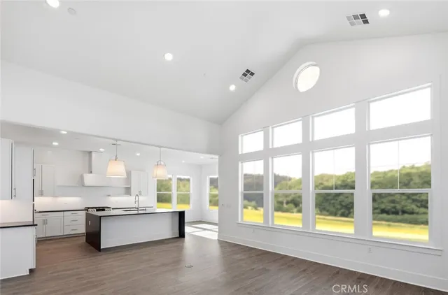 a large white kitchen with a large window