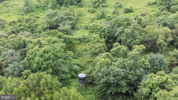 an aerial view of a houses with a yard