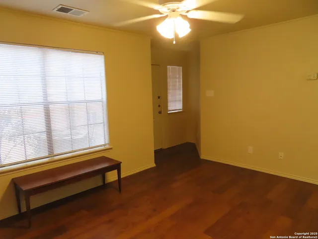 a room with wooden floor and a window