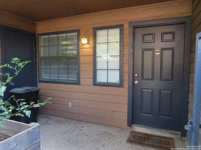 a wooden bench sitting in front of a building