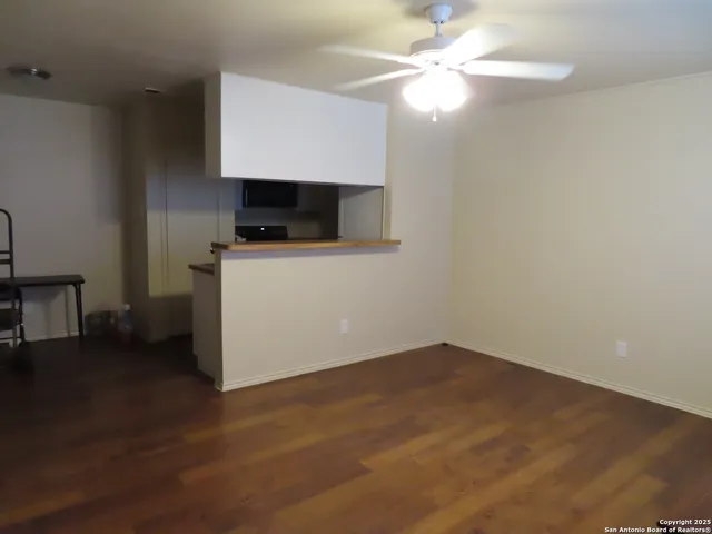 a view of room with a window and ceiling fan