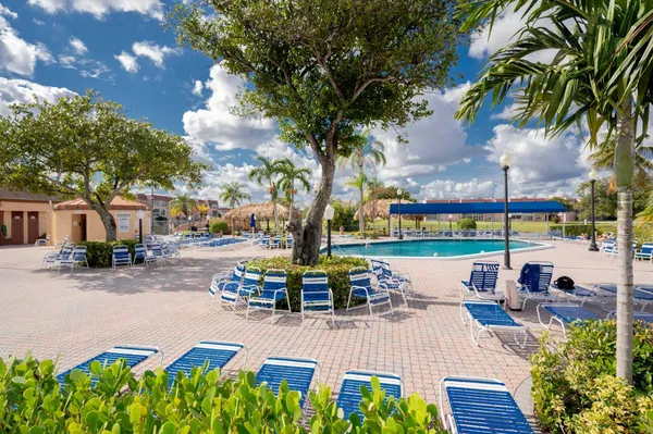 a view of a lake with couches and a table and chairs under an umbrella