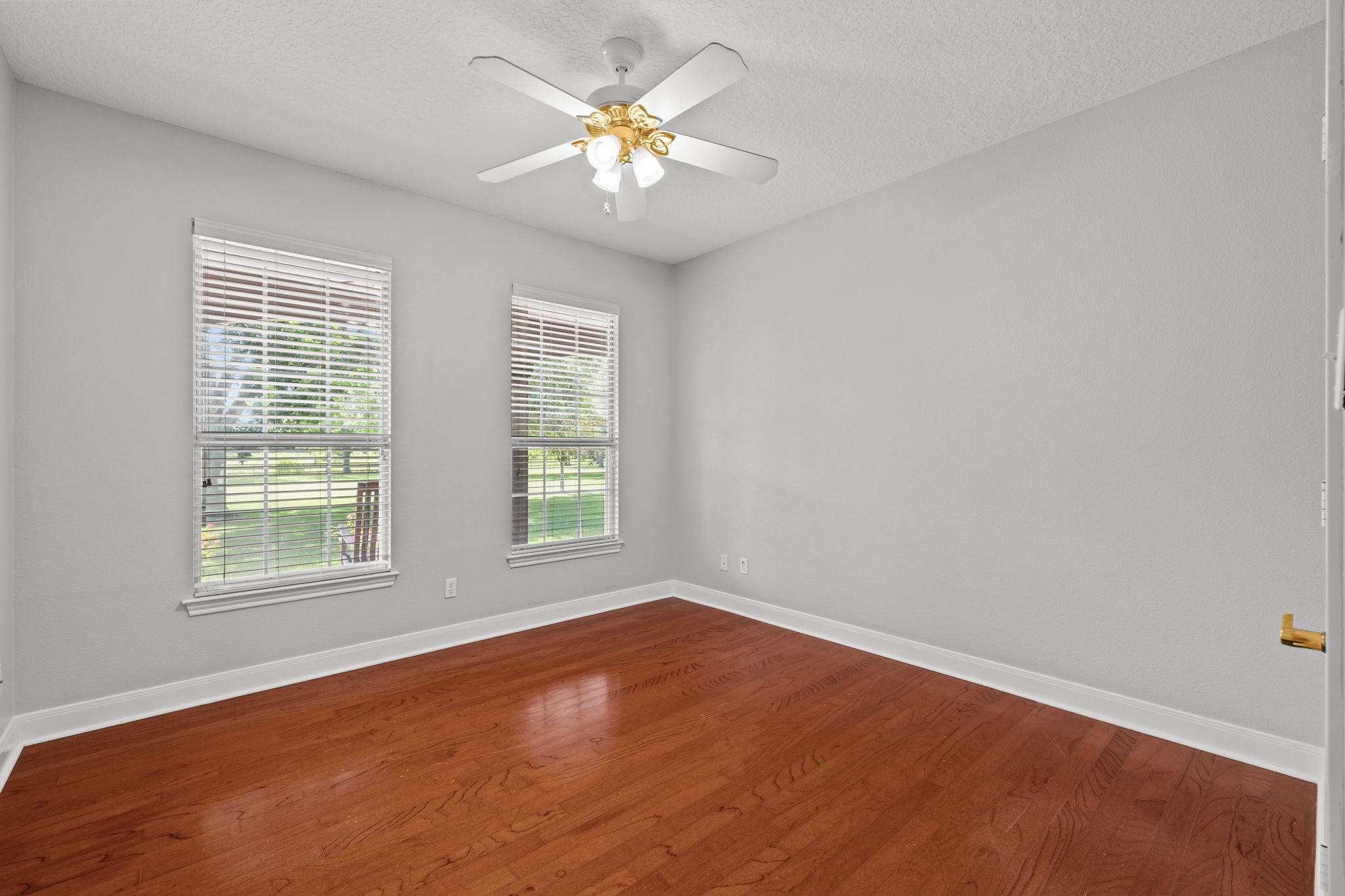 6410 Old Chocolate Bayou Road Manvel, TX 77578 - Photo 26 of 49 Bright secondary bedroom featuring large windows, warm wood flooring, and neutral tones.