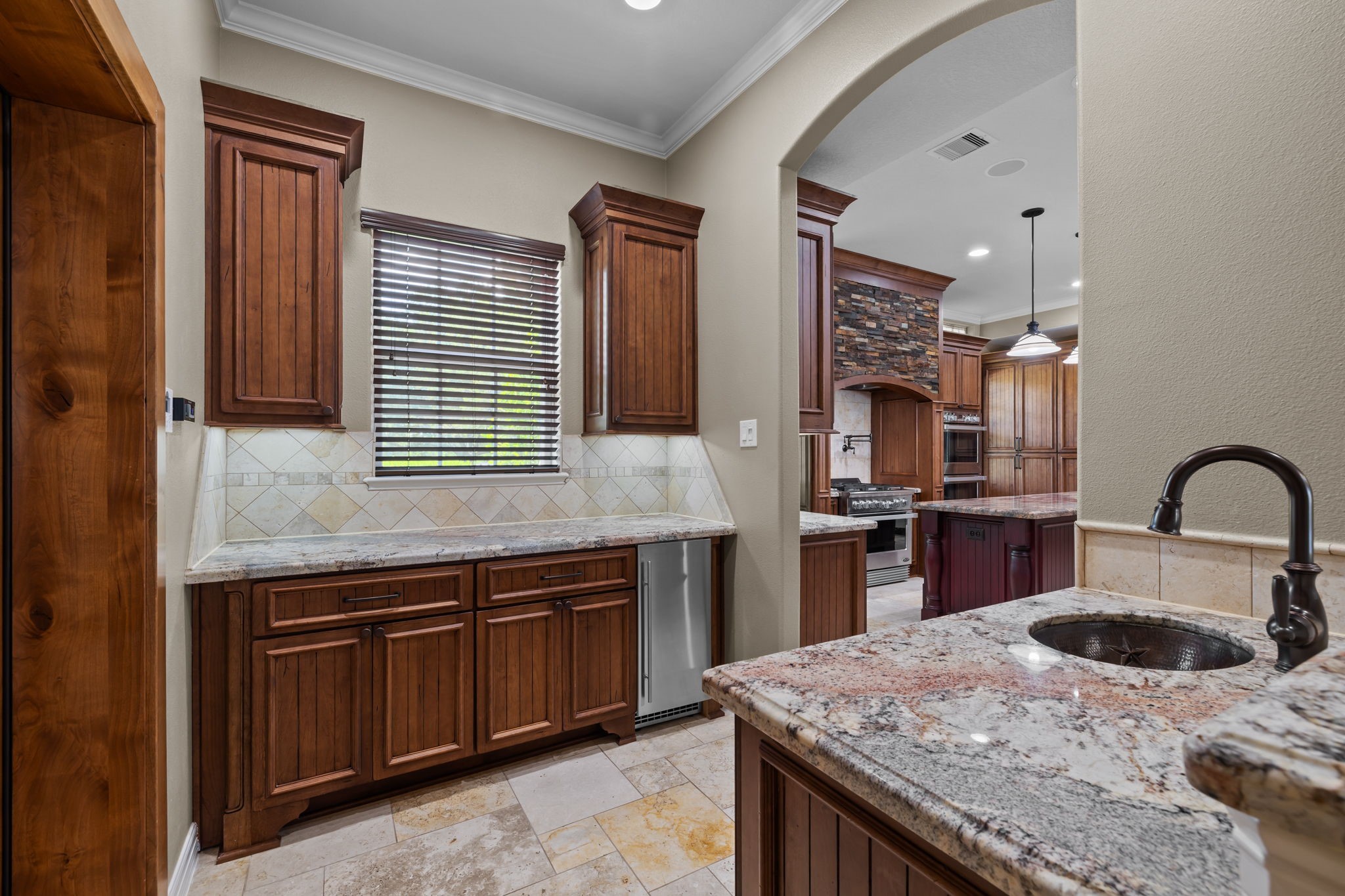 6410 Old Chocolate Bayou Road Manvel, TX 77578 - Photo 28 of 49 Sophisticated wet bar adjacent
to the climate-controlled wine
room, featuring a dedicated
icemaker.