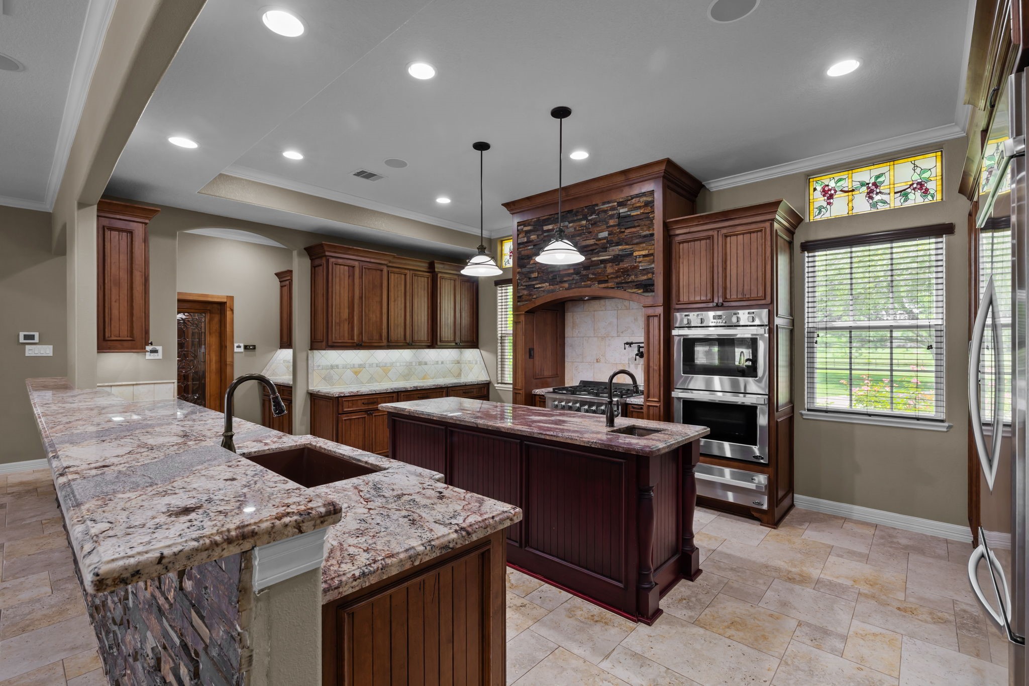 6410 Old Chocolate Bayou Road Manvel, TX 77578 - Photo 29 of 49 This gourmet kitchen features a
built-in refrigerator, sleek prep
sinks with custom granite
counters, whisper-quiet Bosch
dishwasher, and an impressive
setup with dual ovens and
multiple cooktop burners. Perfect
for culinary enthusiasts!
