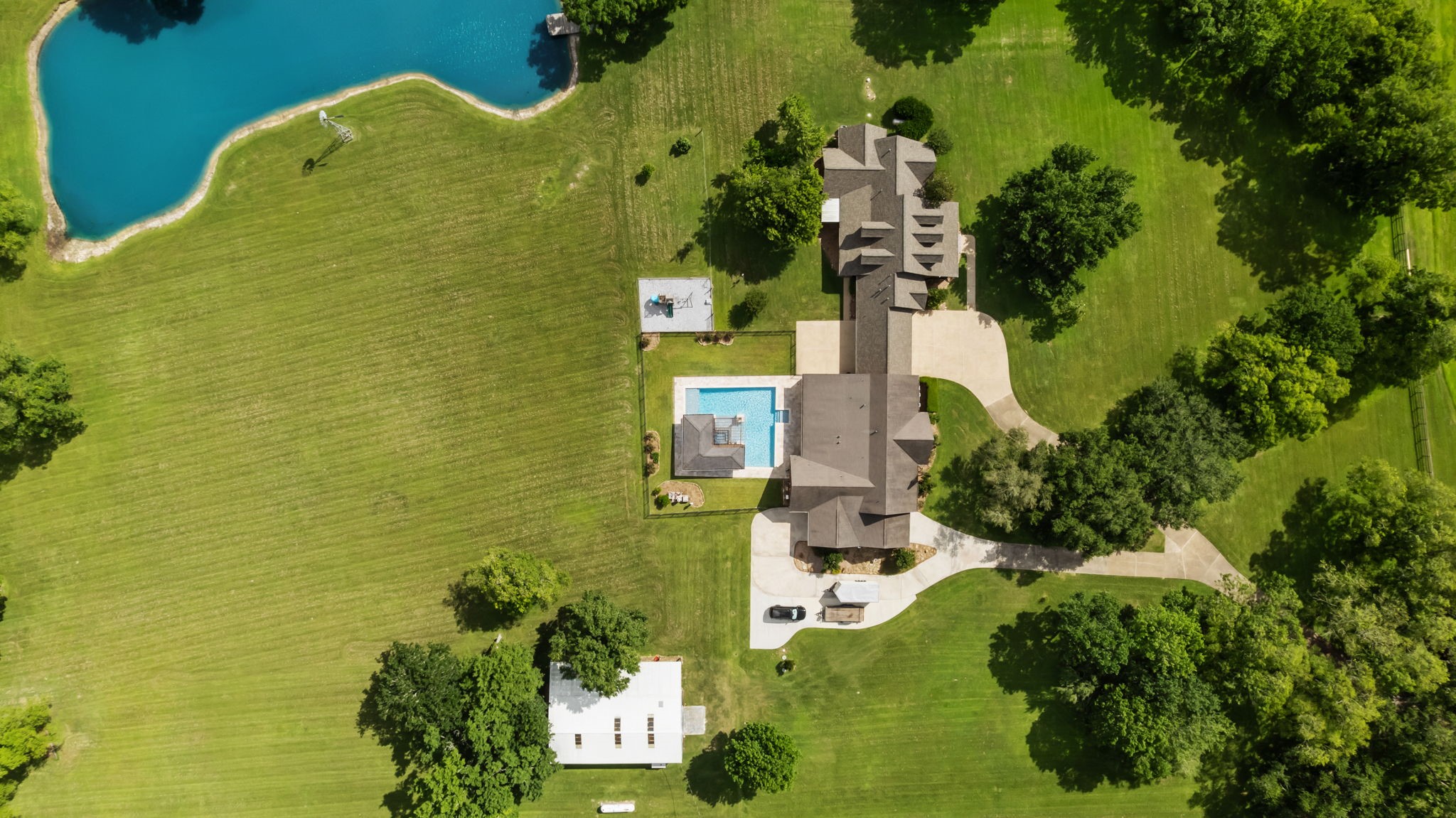 6410 Old Chocolate Bayou Road Manvel, TX 77578 - Photo 3 of 49 Explore this breathtaking 10-acre
estate featuring a serene pond,
luxurious pool, and relaxing spa.
