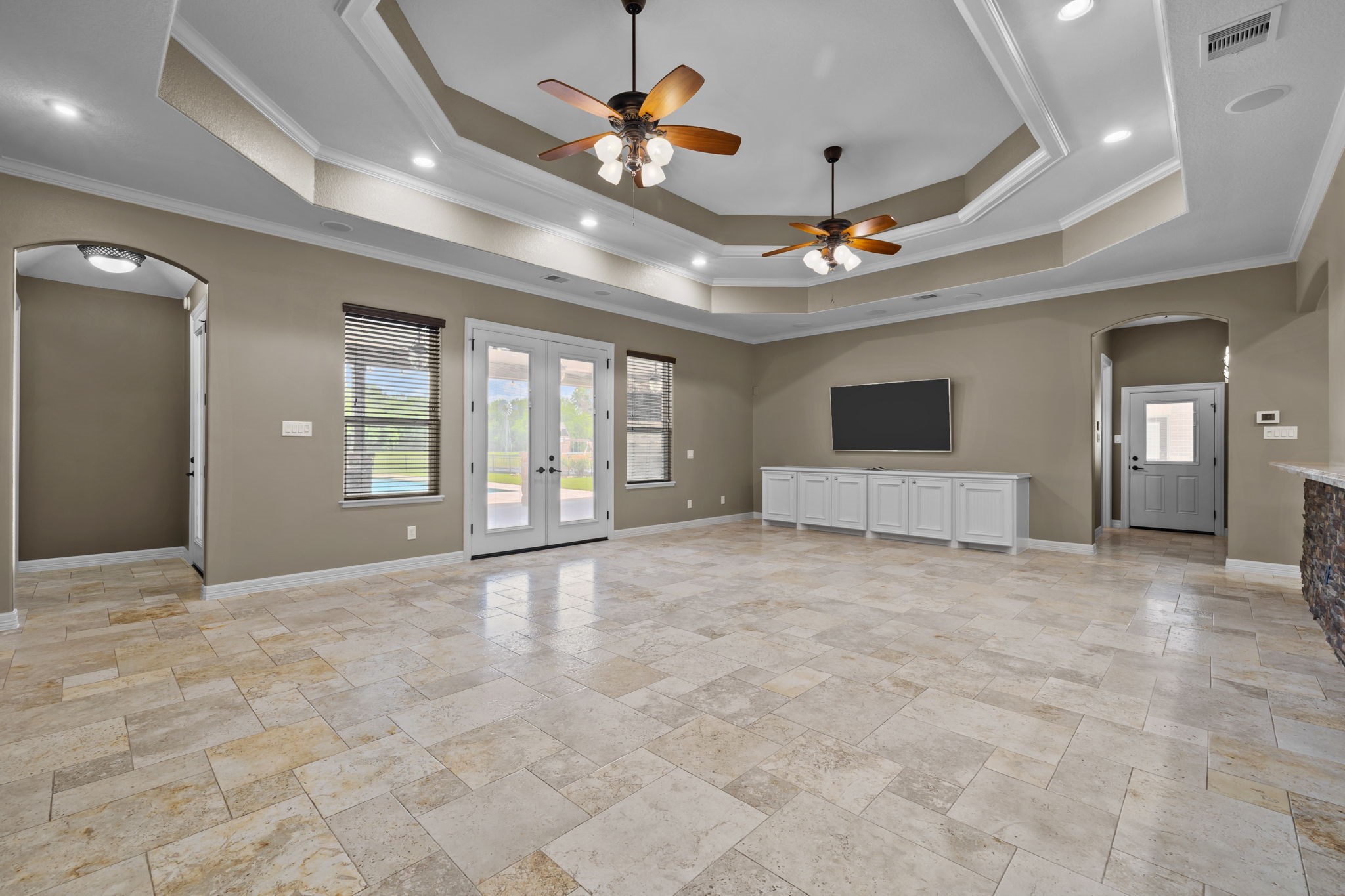 6410 Old Chocolate Bayou Road Manvel, TX 77578 - Photo 33 of 49 Seamless indoor-outdoor living with French doors opening to the covered entertainment pavilion, complete with outdoor kitchen and a sparkling pool/spa.