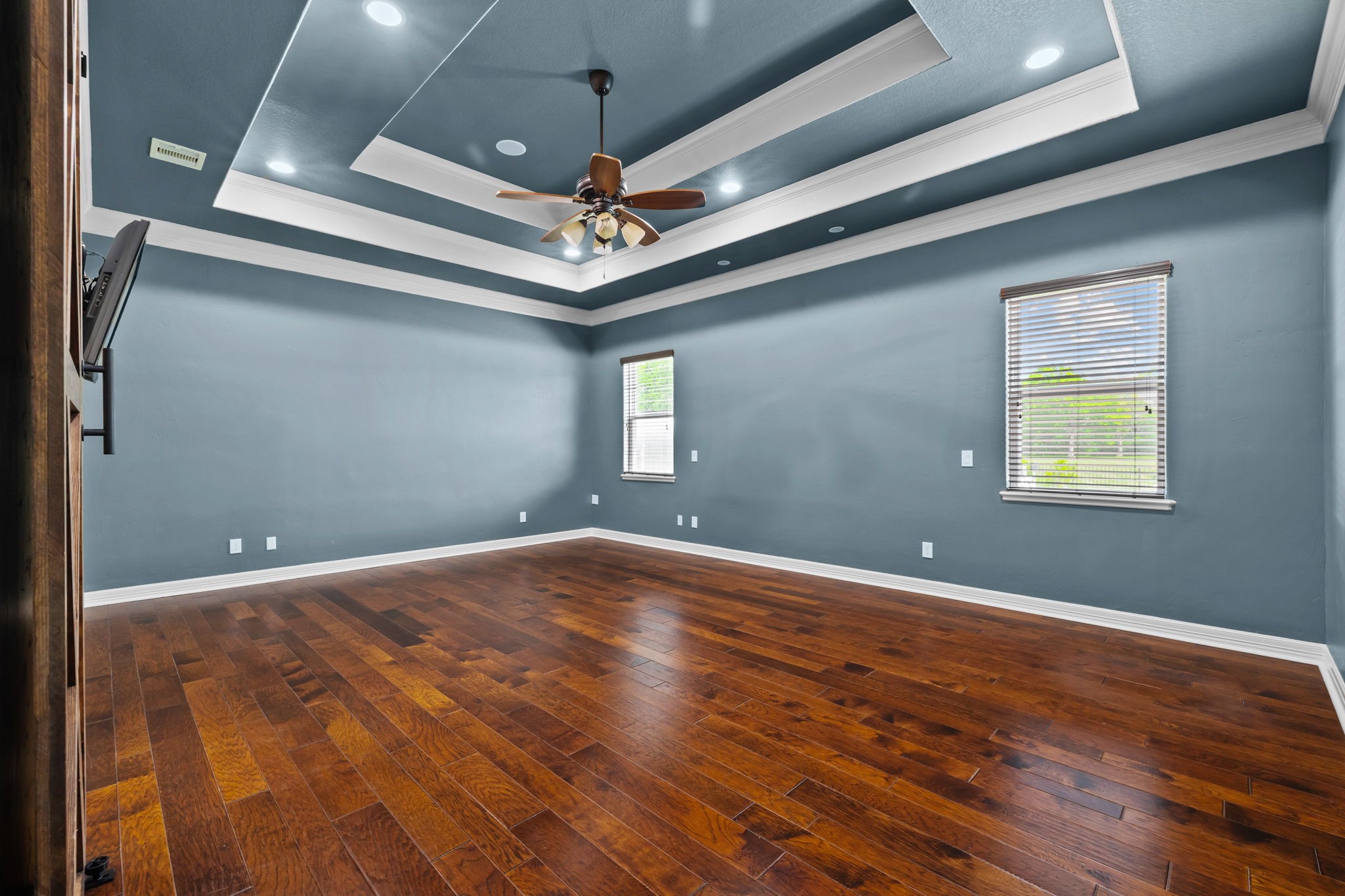 6410 Old Chocolate Bayou Road Manvel, TX 77578 - Photo 36 of 49 Luxurious primary bedroom with
an elegant ensuite bathroom,
featuring rich wood floors and a
stylish barn door.