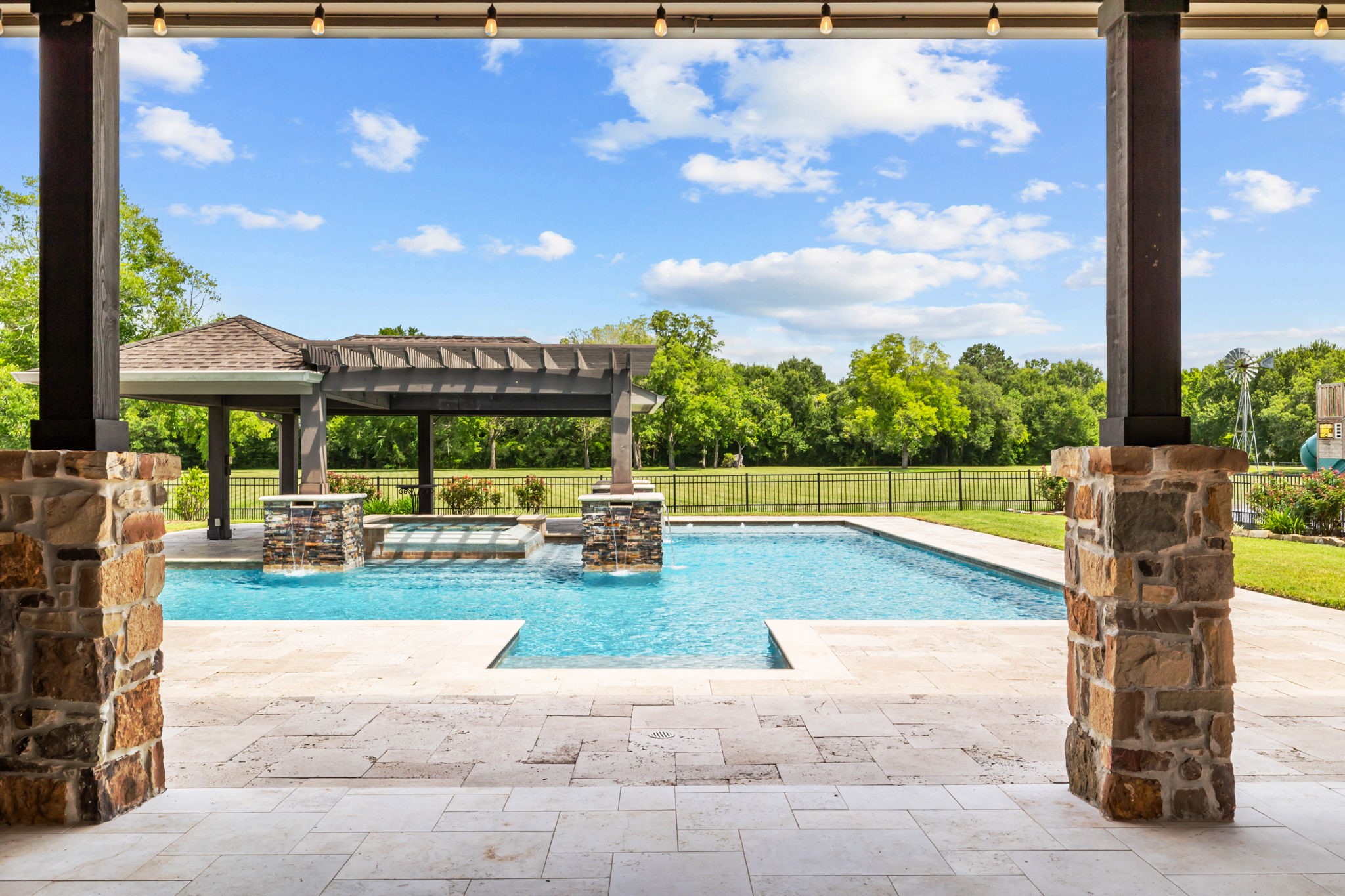 6410 Old Chocolate Bayou Road Manvel, TX 77578 - Photo 43 of 49 Enjoy serene views of the pool
and spa from the comfort of your
covered patio.