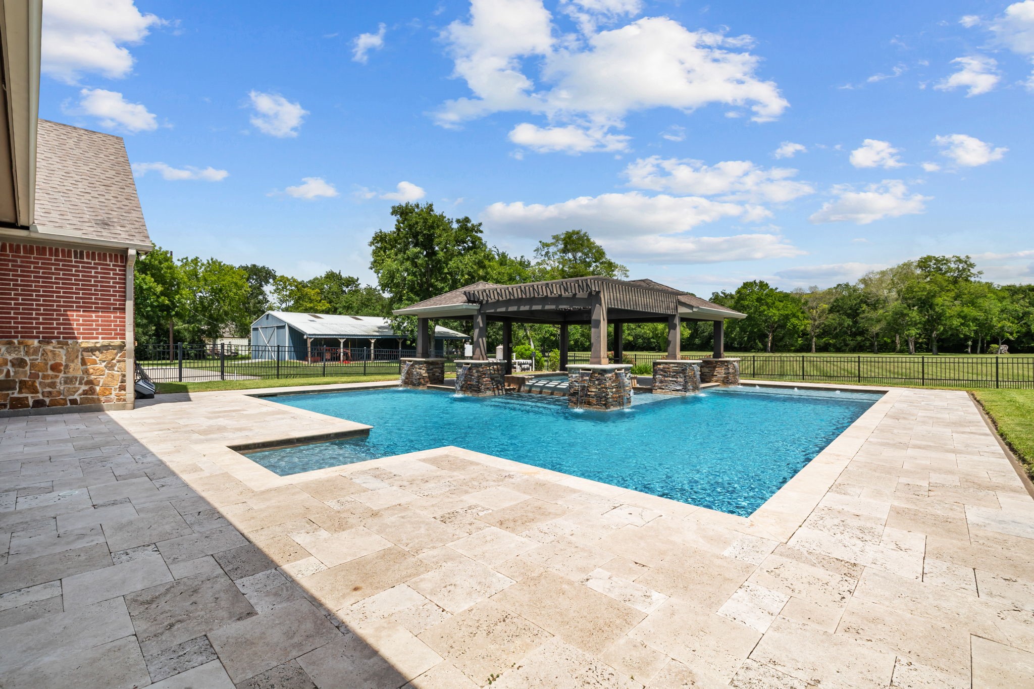 6410 Old Chocolate Bayou Road Manvel, TX 77578 - Photo 5 of 49 Experience luxury with a lagoon style pool featuring tanning
ledges, a spa, and volleyball ready pole inserts.