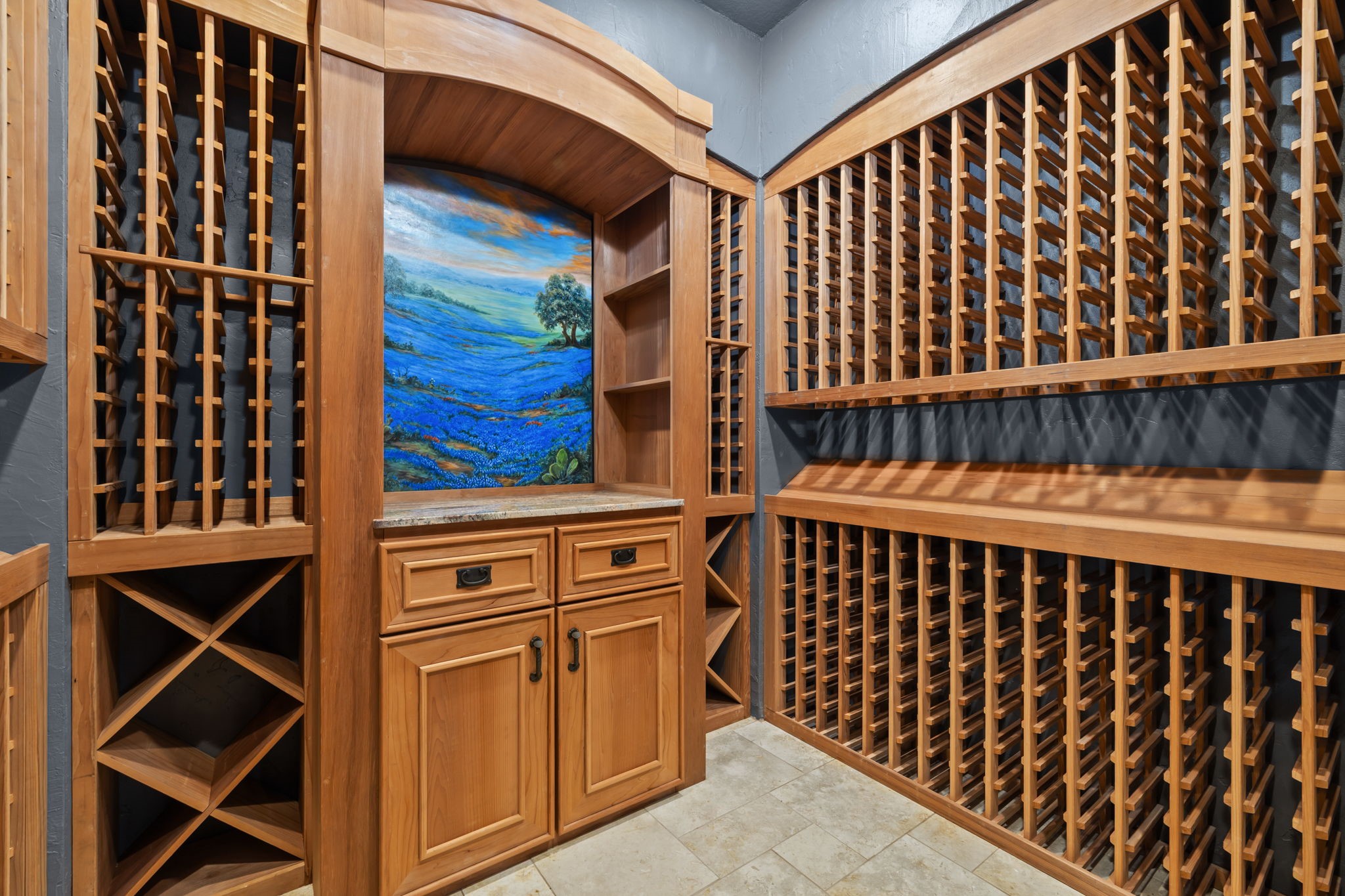 6410 Old Chocolate Bayou Road Manvel, TX 77578 - Photo 6 of 49 This custom-built wine cellar
holds over 1,000 bottles,
featuring a stunning Texas Hill
Country mural. It includes
closed-cell foam insulated walls
and a WhisperKool system for
perfect 55° storage.