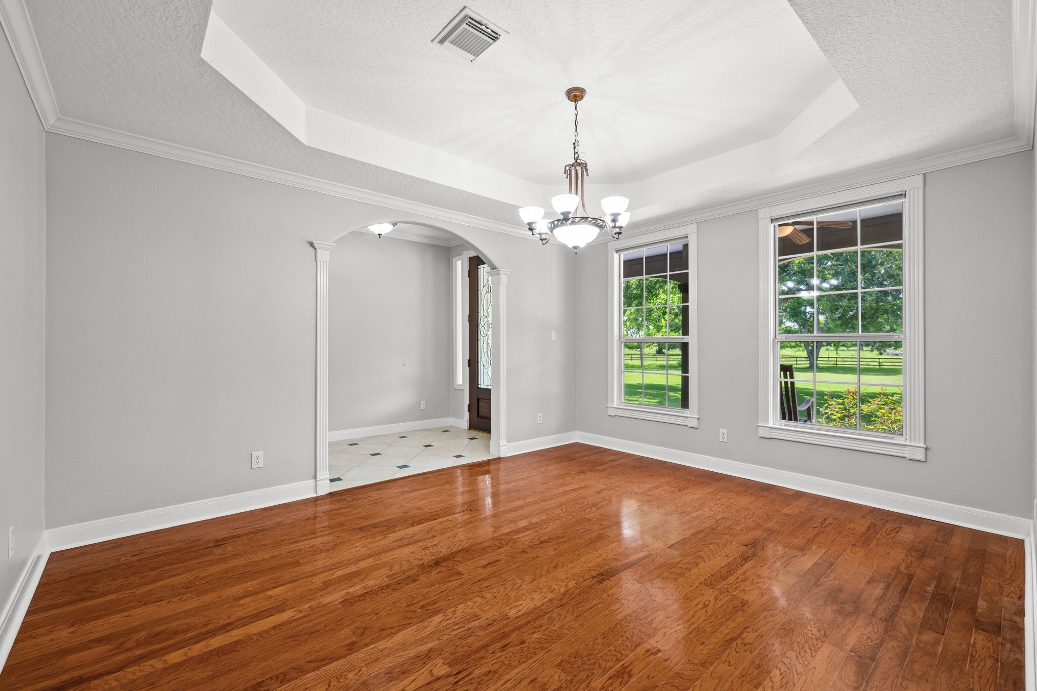 6410 Old Chocolate Bayou Road Manvel, TX 77578 - Photo 9 of 49 Elegant dining room with
hardwood floors, abundant
natural light, and a stylish
chandelier, perfect for hosting
gatherings.
