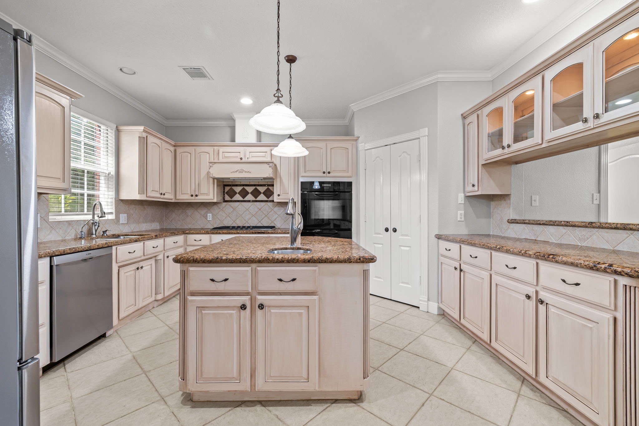 6410 Old Chocolate Bayou Road Manvel, TX 77578 - Photo 10 of 49 This is one of the home's two
stunning kitchens, featuring
elegant cabinetry, modern
appliances, and a spacious
island perfect for entertaining
and culinary adventures.