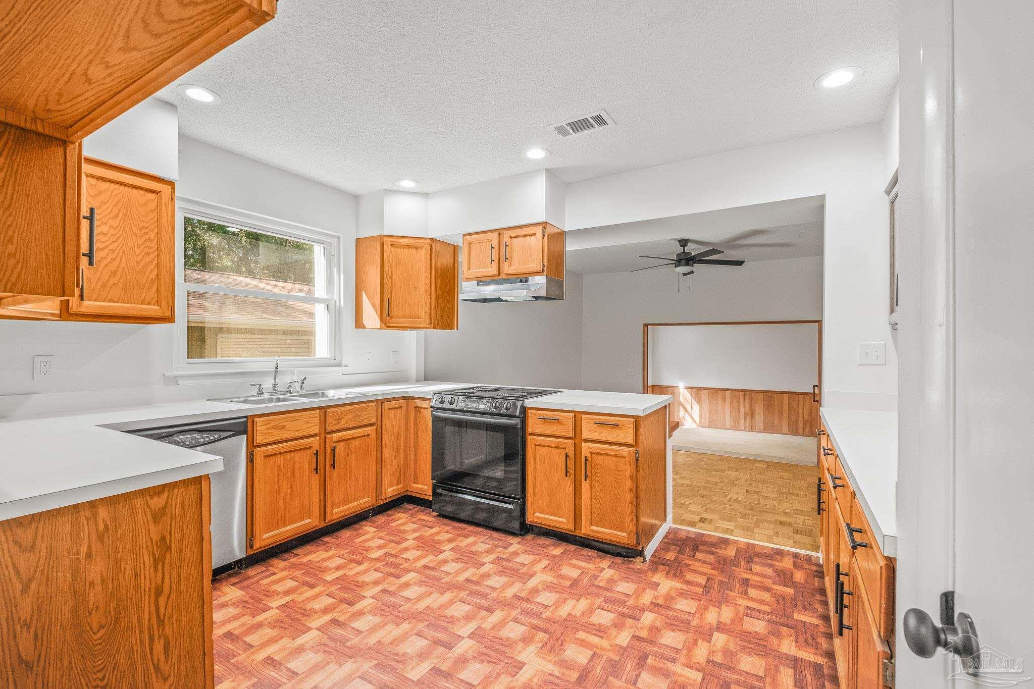 4928 Shell Road Milton, FL 32583 - Photo 16 of 60 a kitchen with stainless steel appliances granite countertop sink stove and granite counter top
