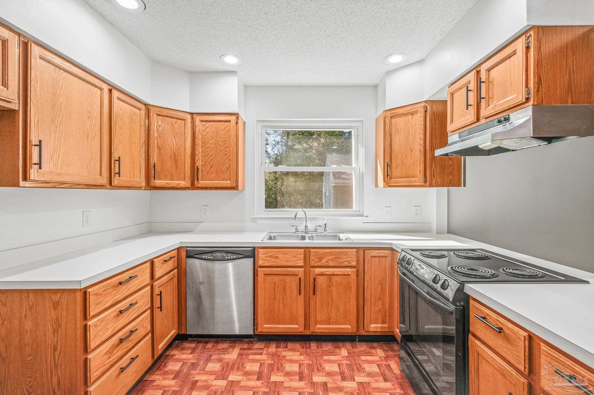 4928 Shell Road Milton, FL 32583 - Photo 17 of 60 a kitchen with a sink stove and cabinets