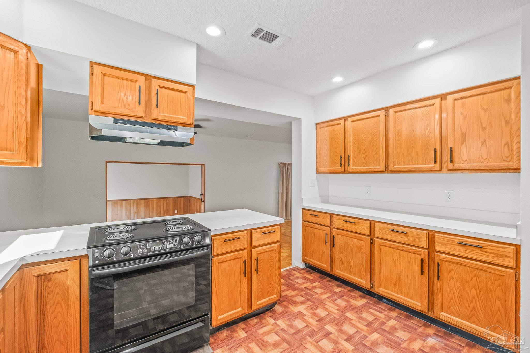 4928 Shell Road Milton, FL 32583 - Photo 18 of 60 a kitchen with stainless steel appliances granite countertop a stove and a sink