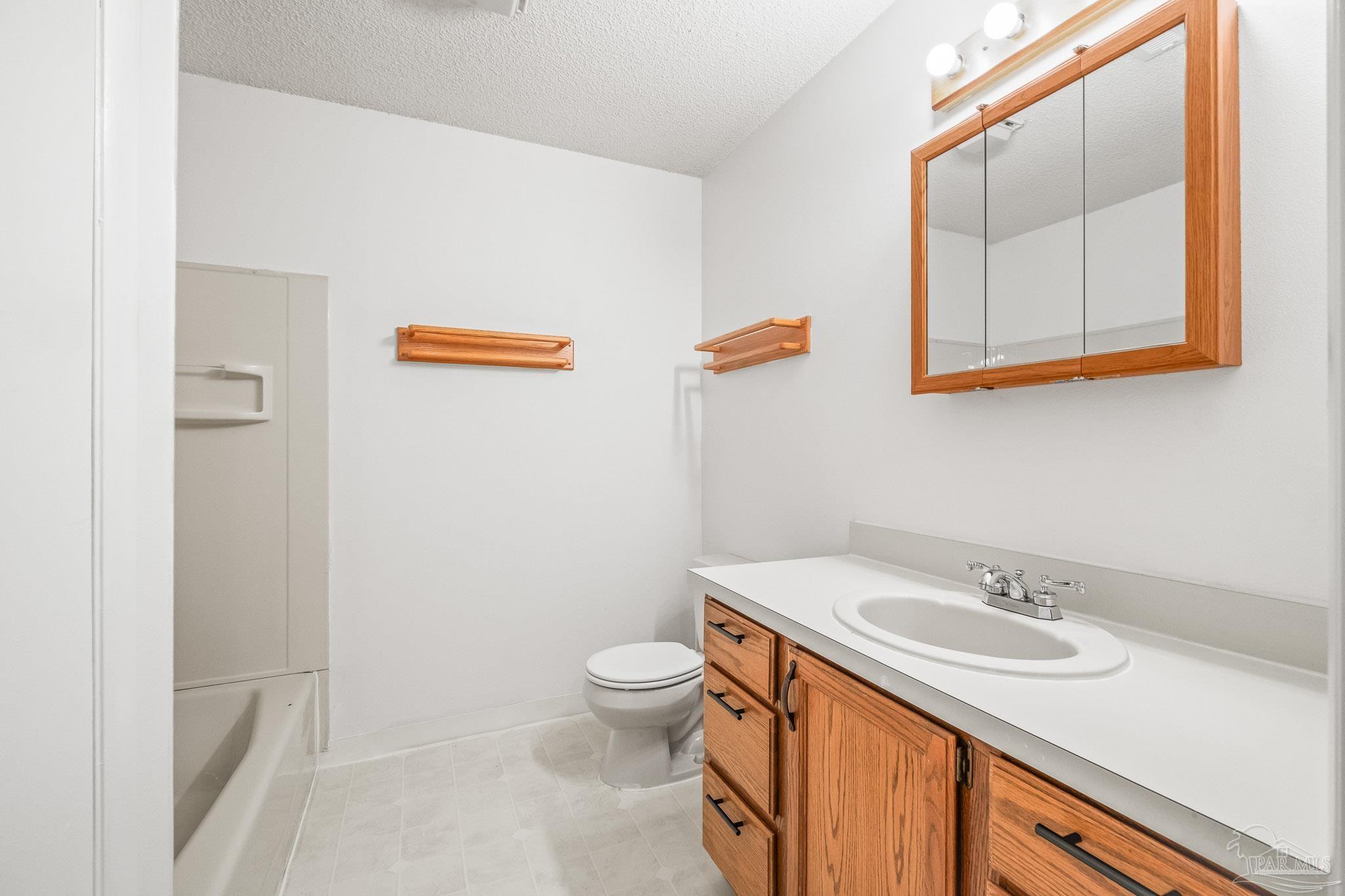 4928 Shell Road Milton, FL 32583 - Photo 36 of 60 a bathroom with a sink and a mirror