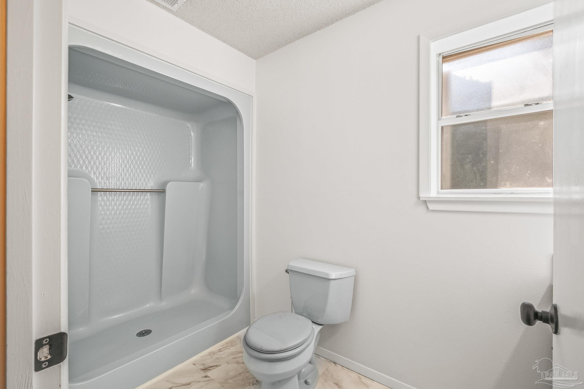 4928 Shell Road Milton, FL 32583 - Photo 45 of 60 a bathroom with a shower a toilet and sink