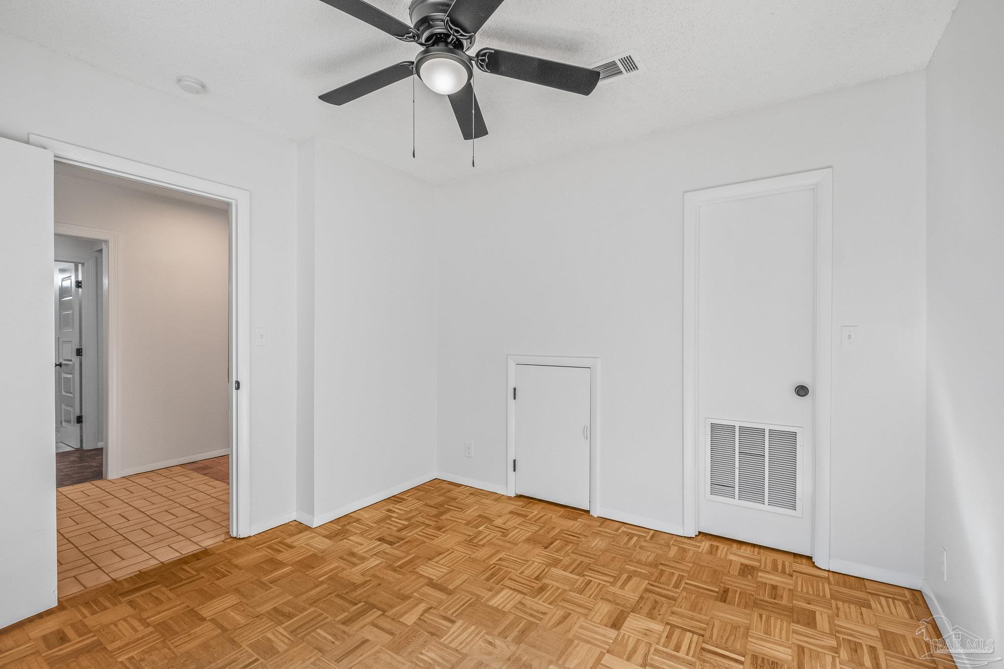 4928 Shell Road Milton, FL 32583 - Photo 8 of 60 a bedroom with a bed and a chandelier fan