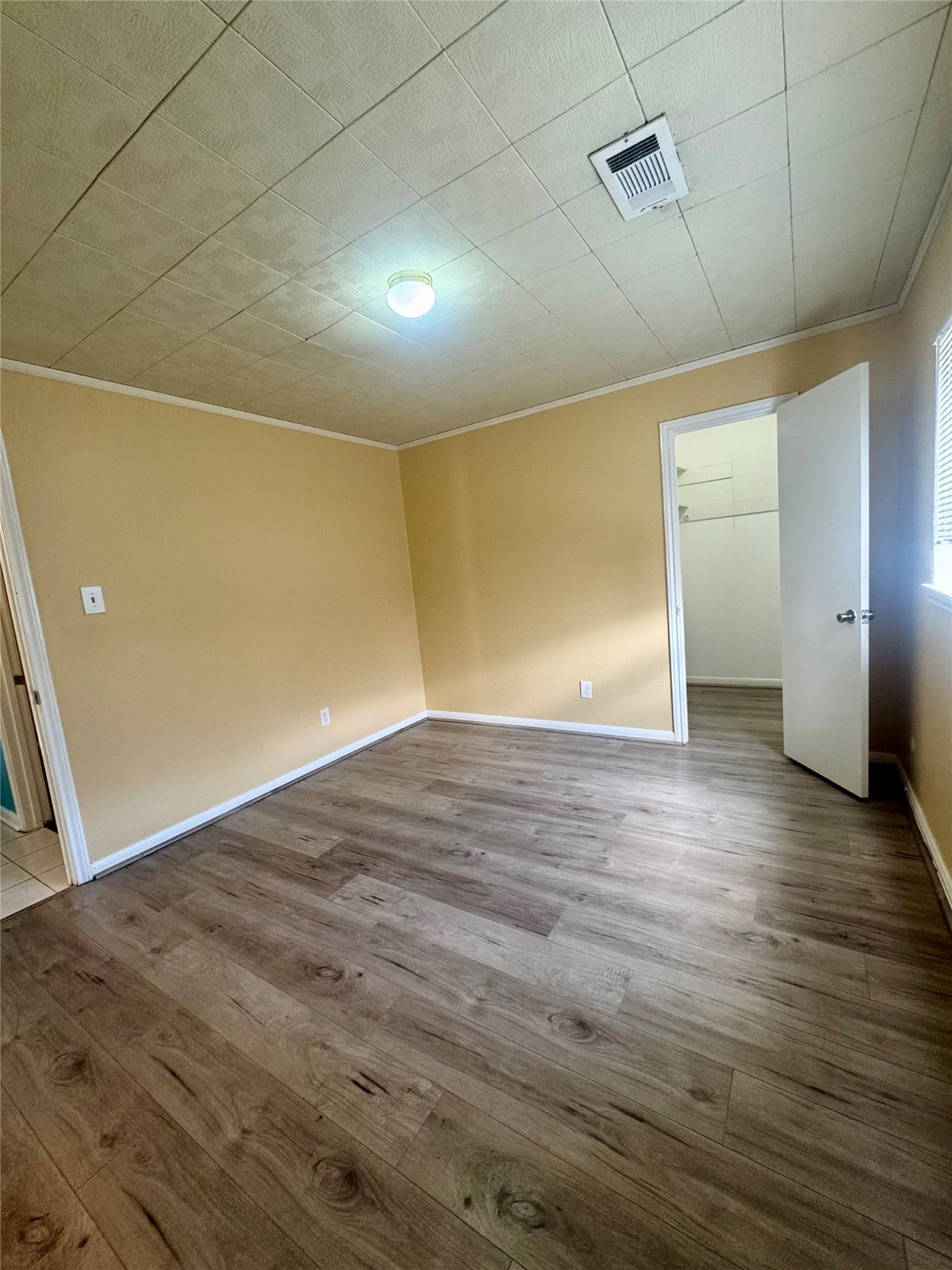 8418 Hazen Street Houston, TX 77036 - Photo 13 of 25 an empty room with wooden floor and windows