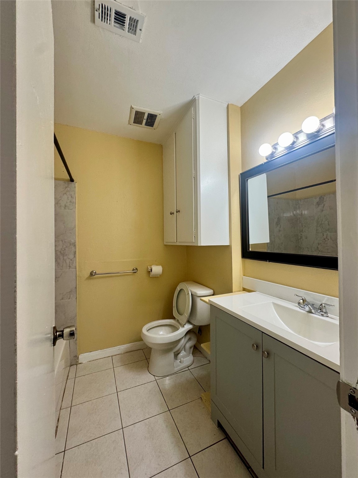 8418 Hazen Street Houston, TX 77036 - Photo 15 of 25 a bathroom with a sink a mirror and a toilet