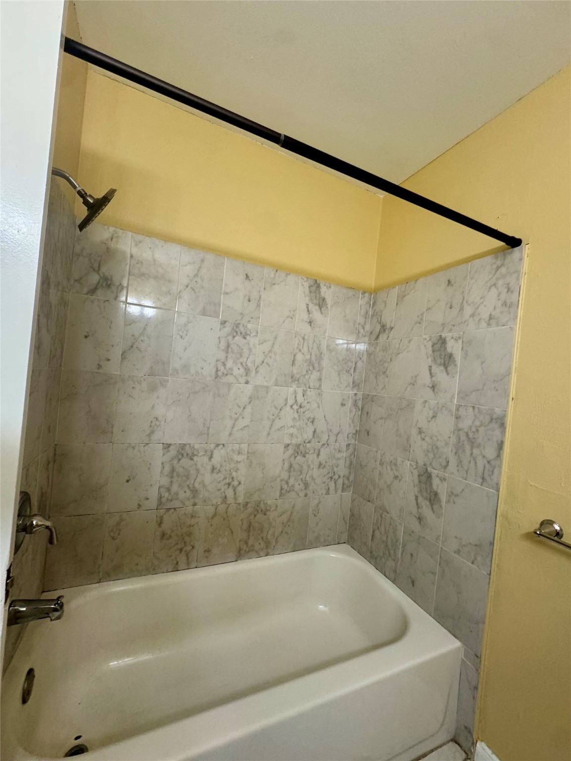 8418 Hazen Street Houston, TX 77036 - Photo 16 of 25 a bathroom with a shower and a bath tub