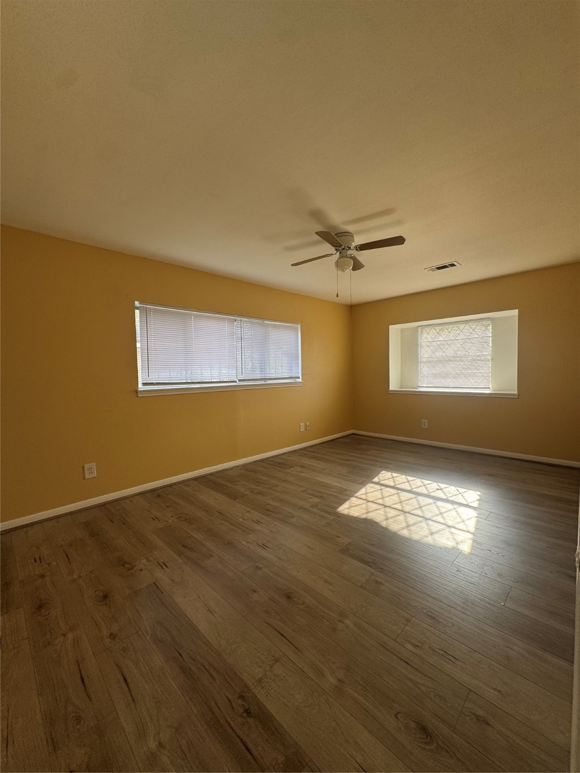 8418 Hazen Street Houston, TX 77036 - Photo 18 of 25 a view of empty room with wooden floor and fan